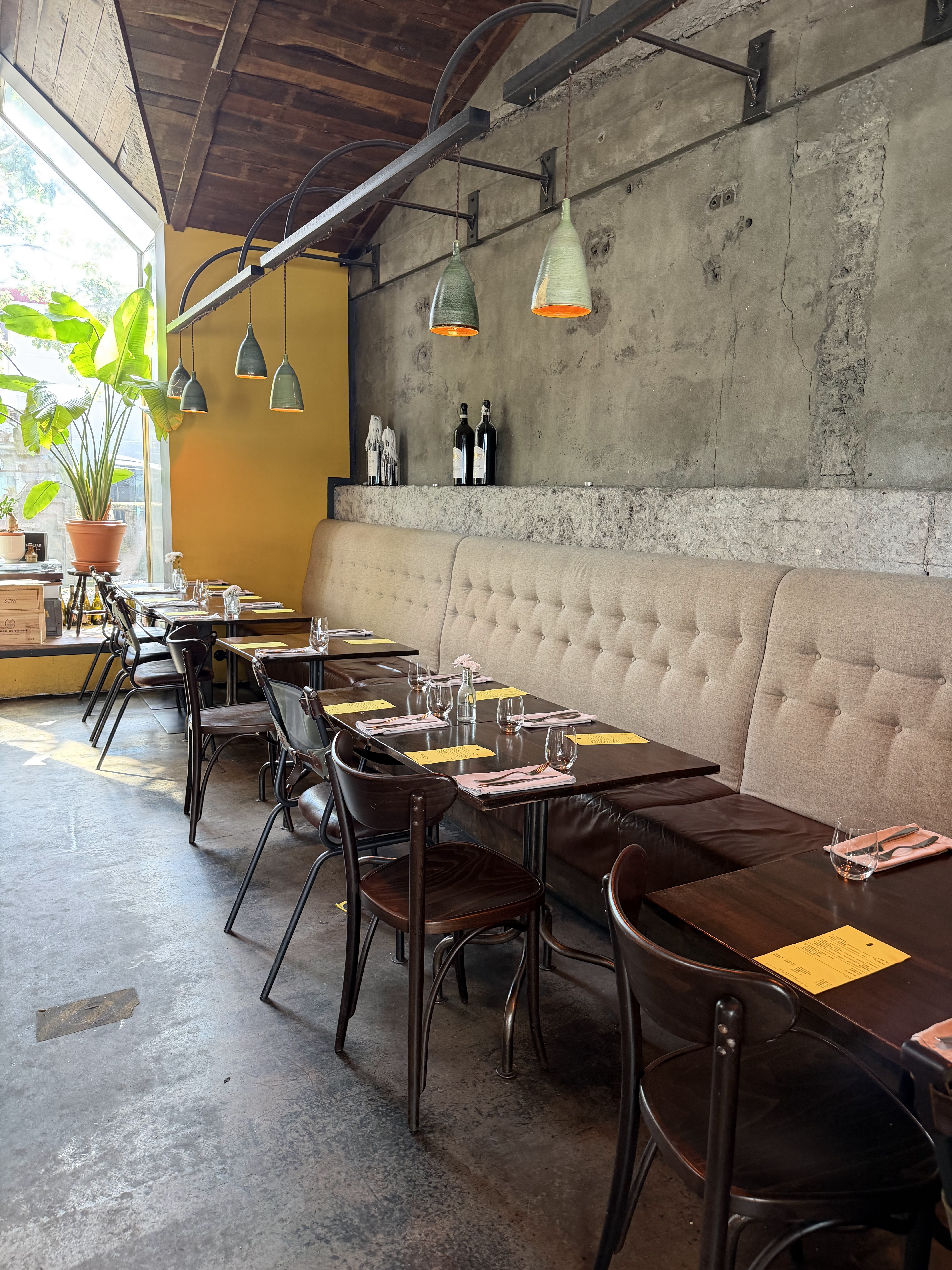 Hosiló dining room with banquette seating and pendant lamps
